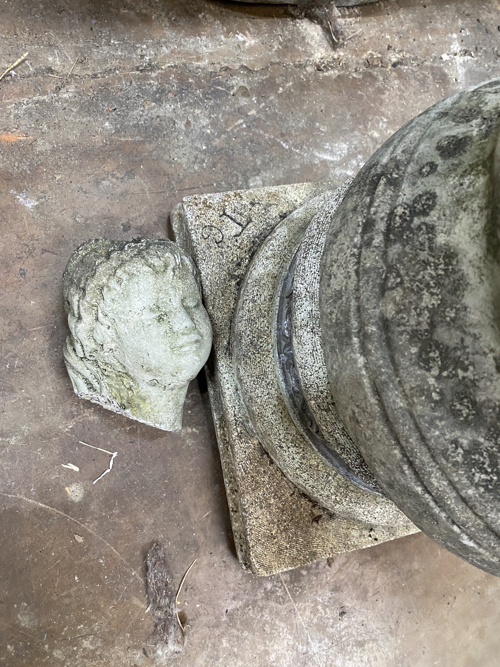 A reconstituted stone garden statue of a lady holding a dove, head detached, height 95cm